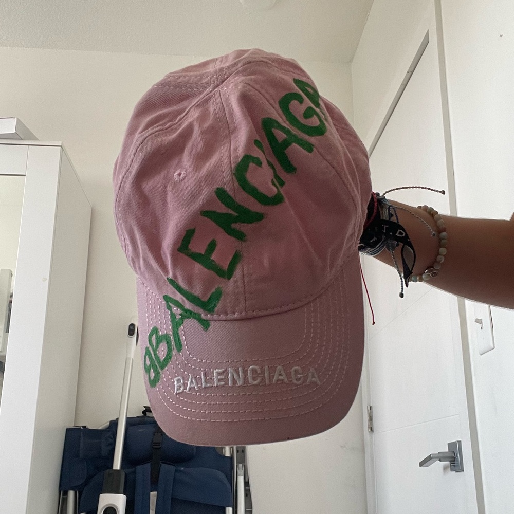 Pink Balenciaga Cap with Green Lettering Written Over It.
